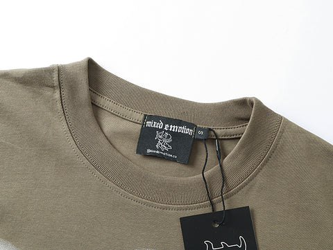 MIXED EMOTIO Blindfolded Cherub Rhinestone Olive Graphic Short Sleeve T‑Shirt